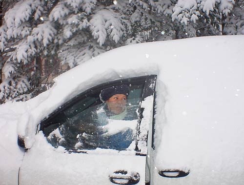 driver in snow covered vehicle