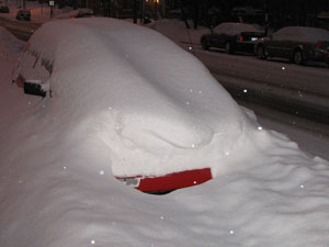car buried under snow parked on a montreal street