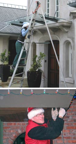 on a ladder installing christmas lights