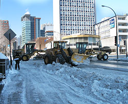 snow removal equipment blocks a busy montreal intersection